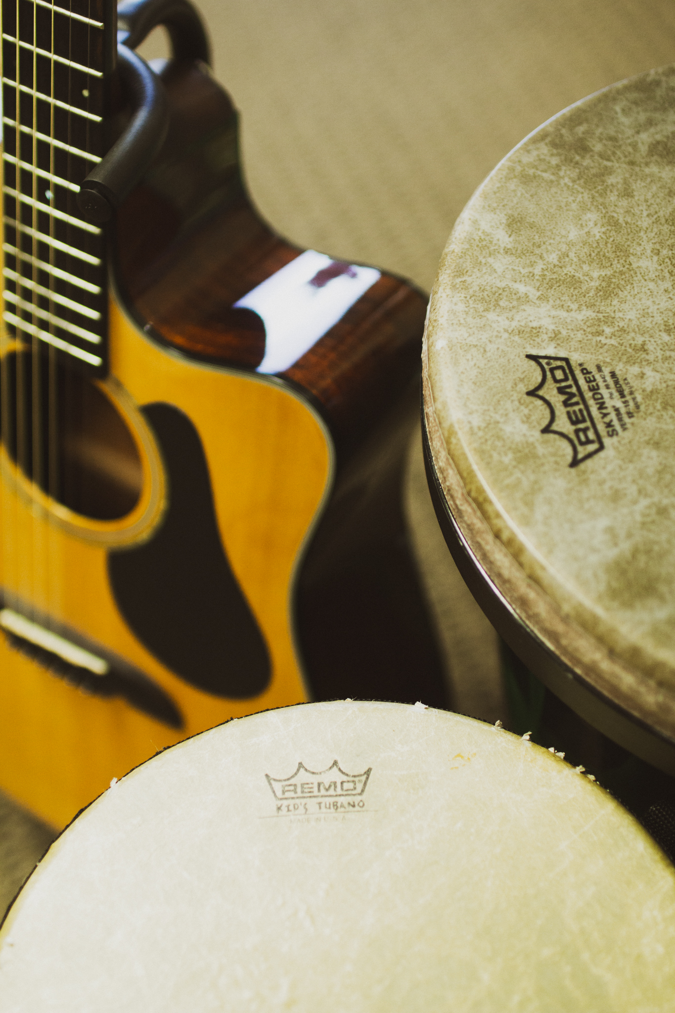 Close up image of a guitar and two large tubano drums