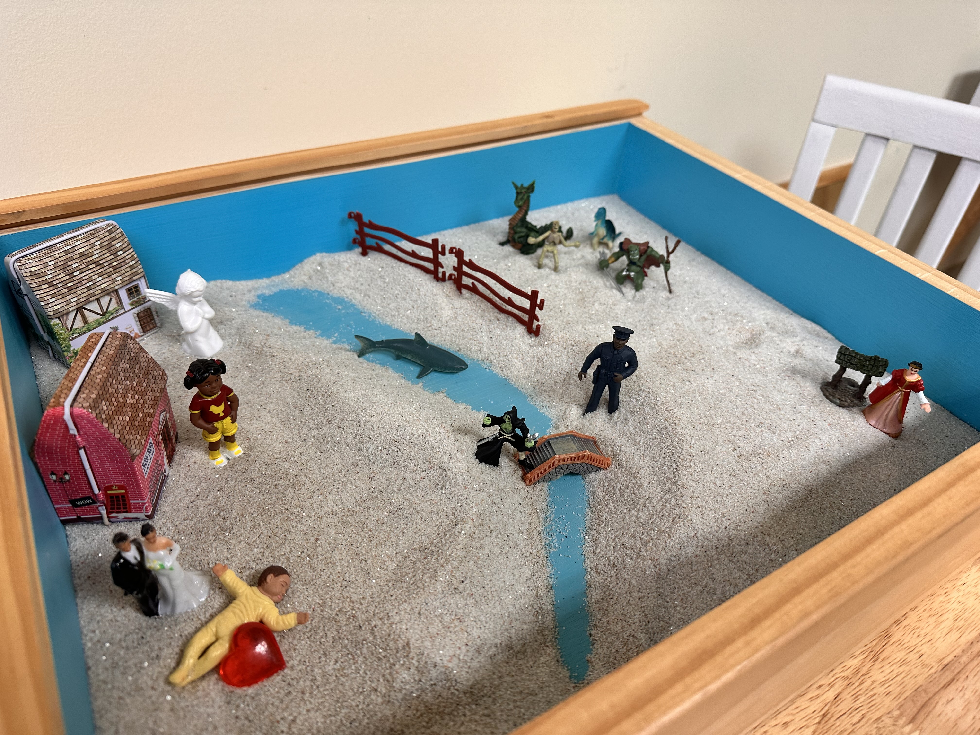 Sand tray with figurines used in play therapy